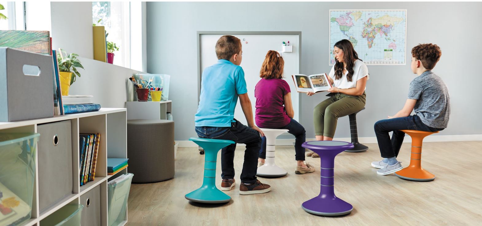 3 children and teacher sitting on ricochet stools