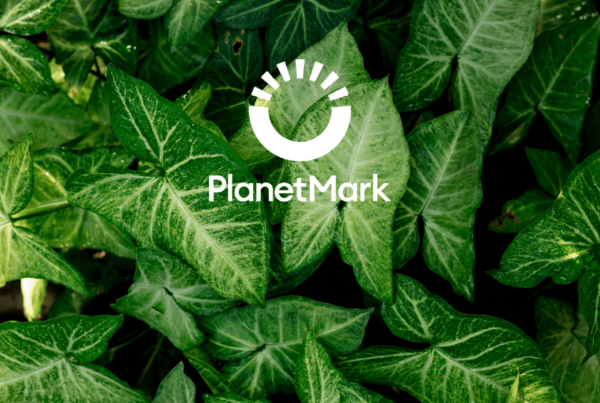 Planet Mark Logo on Green Leaf Background